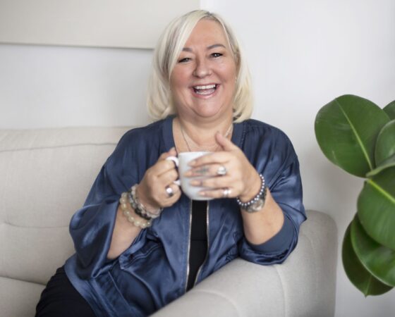 Thumb nail Frances Bentley Coach Bentley Author Motivational Speaker and mentor Blue Jacket and holding cup of coffee
